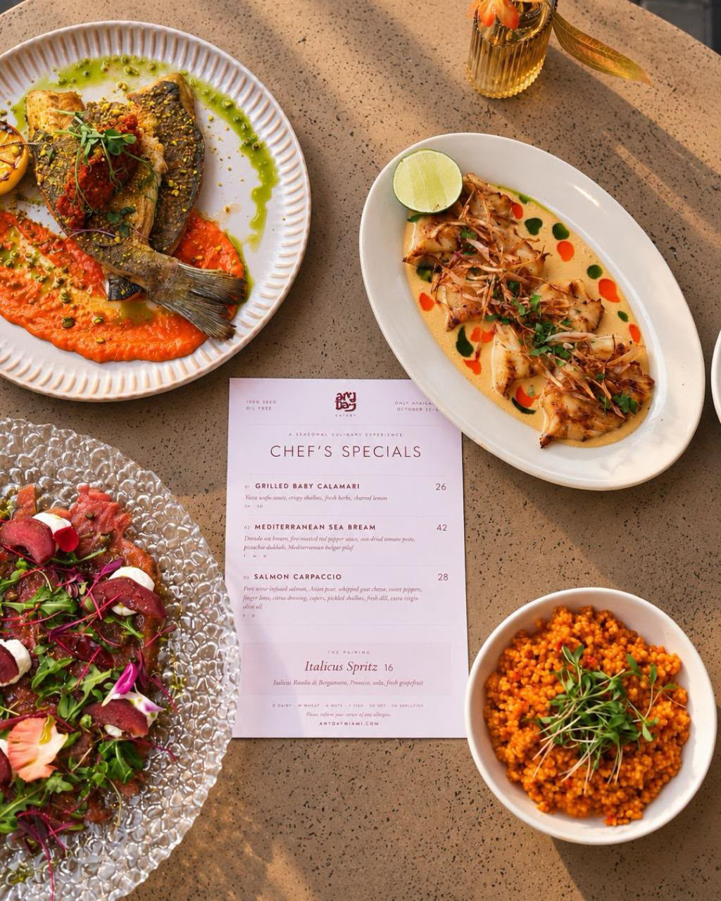 Chef's specials menu flat lay with sea bream, calamari and carpaccio